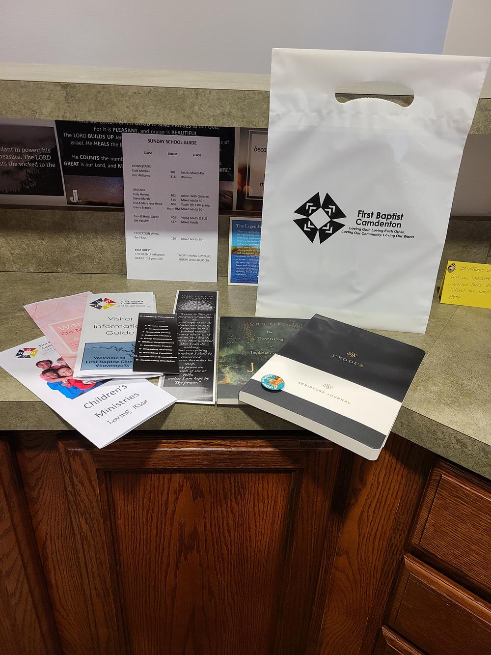 Customer photo from Deborah of our Reinforced Handle Plastic Bag - 13 inches x 9 inches, a group of papers on a counter