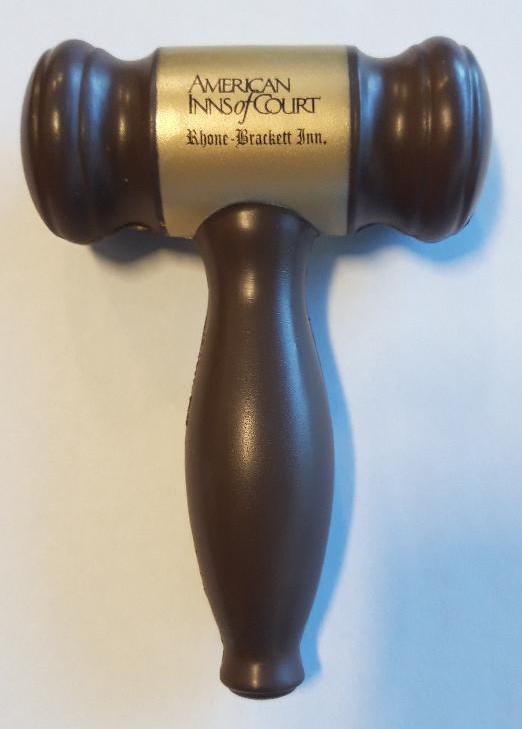 a brown gavel with a gold handle