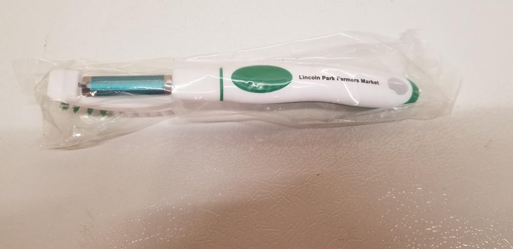 Customer photo from Leslie of our Brush Up Vegetable Brush & Peeler, a white and green toothbrush in a plastic bag