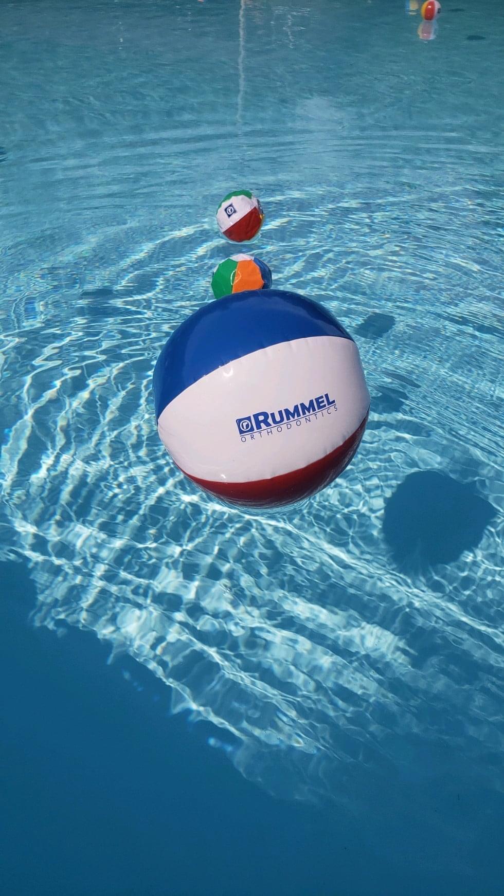 Customer photo from Olivia of our Beach Ball - Mini - 24 hr, a group of beach balls floating in a pool