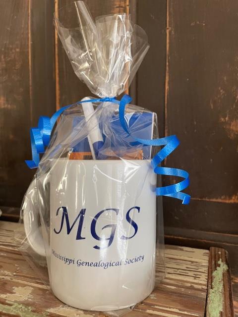 Customer photo from Karen of our Heat Seal Exhibition Tote - 14" x 11", a white mug with blue ribbon and a blue bow in a plastic bag