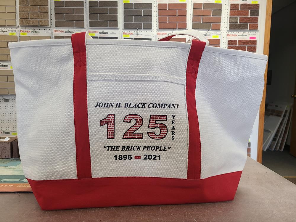 Customer photo from James of our Large Heavyweight Cotton Canvas Tote - Screen, a white and red bag with black text