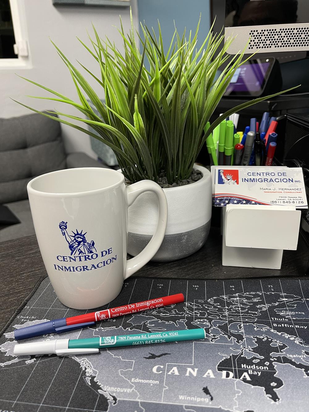 a cup and markers on a desk