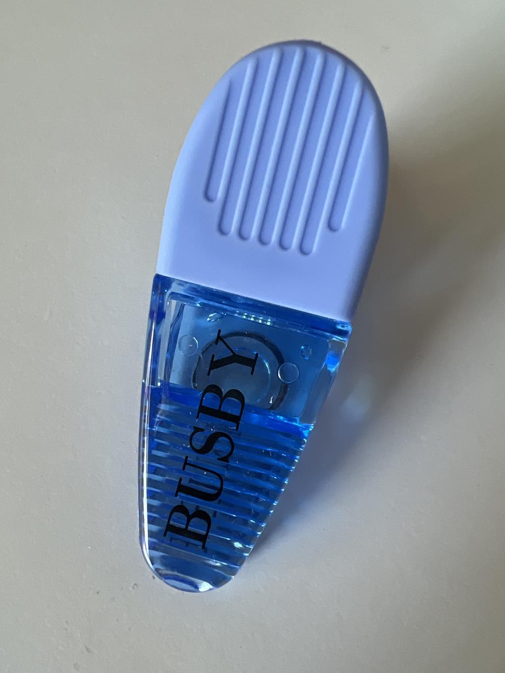 a blue eraser with a blue liquid in it