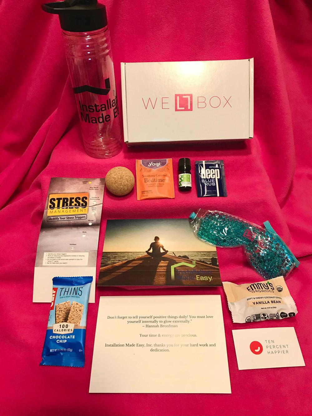 Customer photo from Ian of our Aqua Pearls Hot/Cold Eye Mask, a box with a bottle of water and other items on a pink blanket