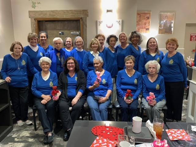 a group of women in blue shirts