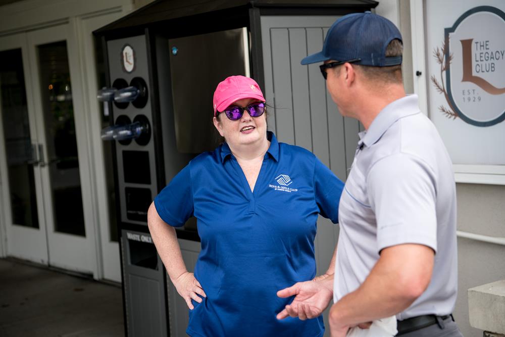 Customer photo from Sabine of our Risky Business Sunglasses - Opaque, a woman in a blue shirt talking to a man
