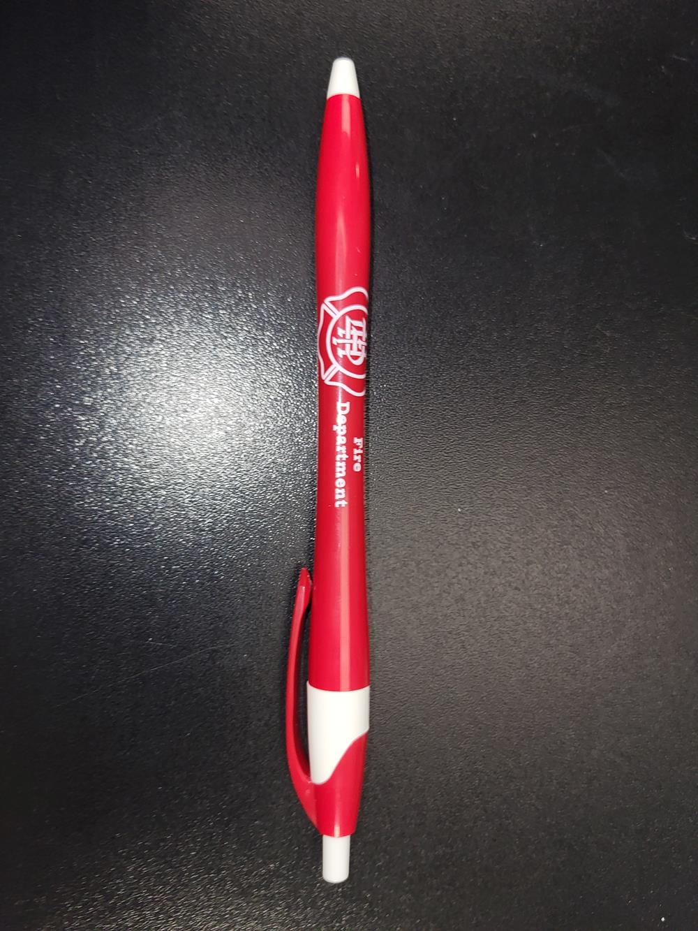 a red pen on a black surface