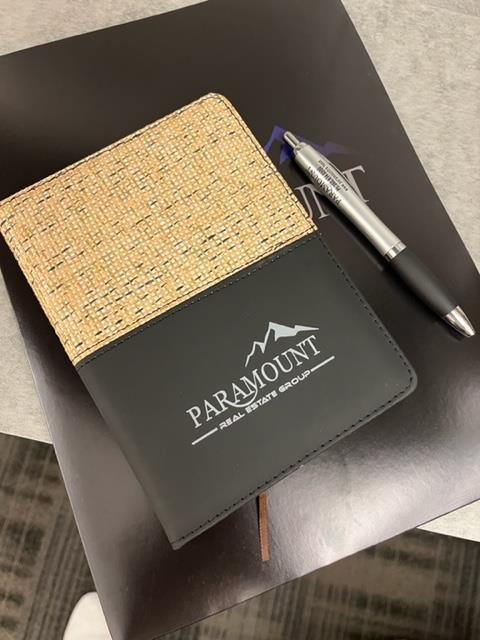 a pen and a notebook on a table