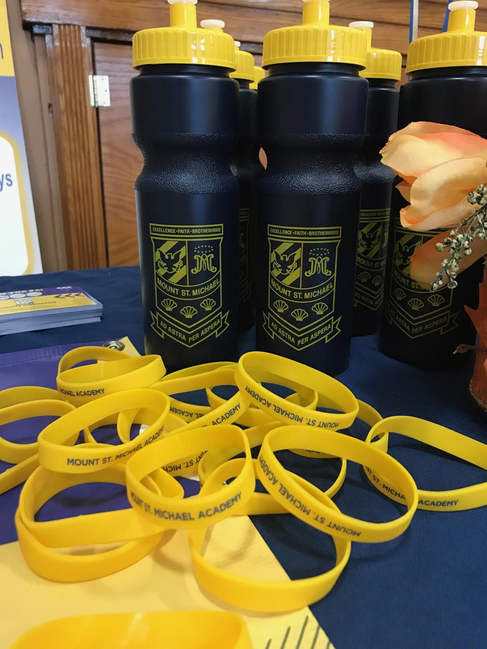 Customer photo from Lisa of our Sport Bottle with Push Pull Lid - 28 oz. - Colors, a group of black bottles with yellow rubber bands