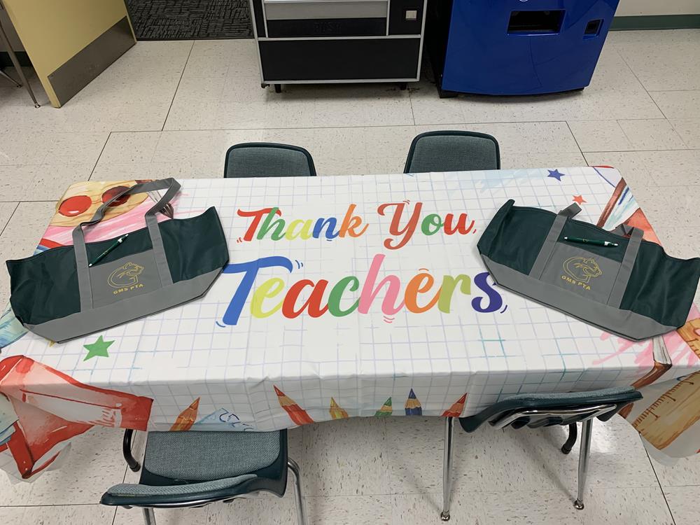 Customer photo from Lauren of our Javelin Pen, a table with a thank you teacher's sign on it