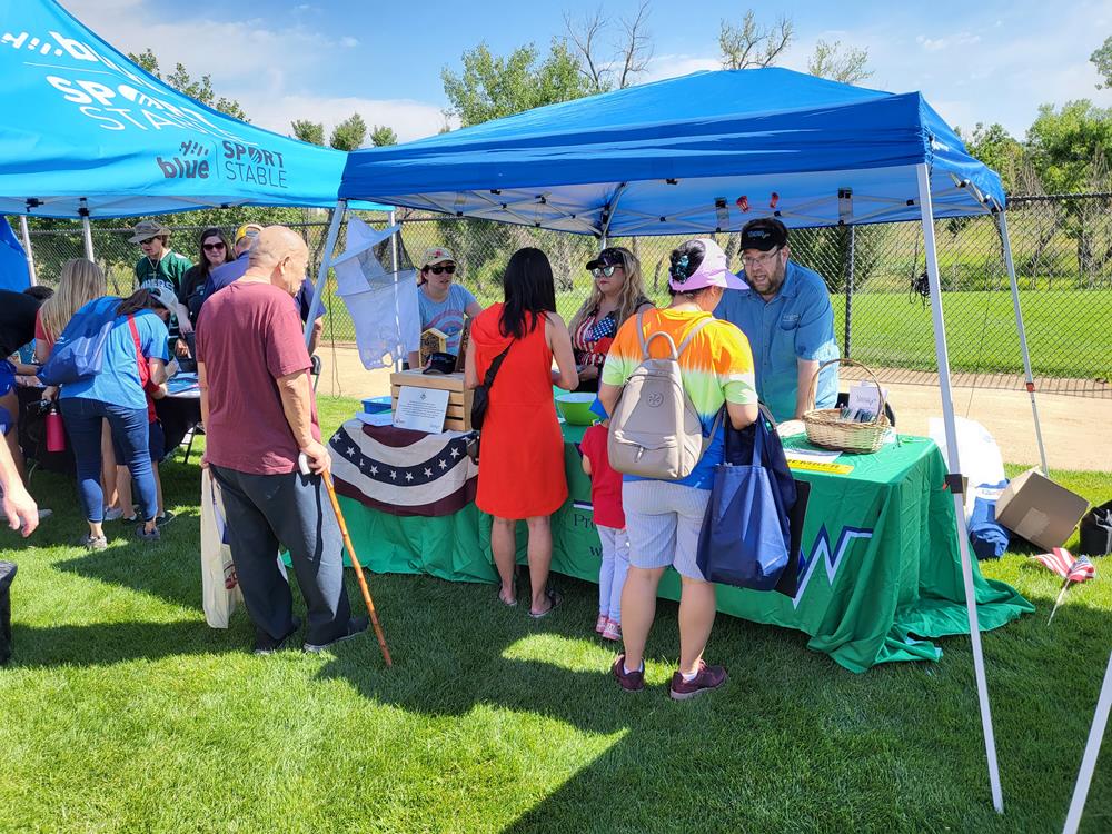 Customer photo from Tom of our Serged Closed-Back Table Throw - 6', a group of people standing around a table