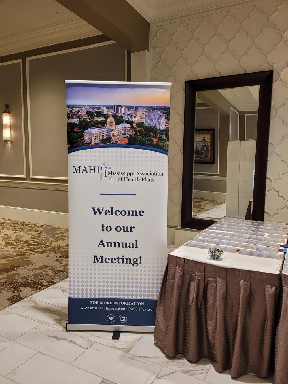 Customer photo from Beckie of our Ideal Retractable Banner Display - 33-1/2", a table with a sign and a mirror