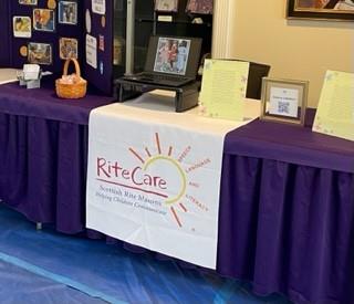 Customer photo from Susan of our Laser Edge Table Runner - 28 inches, a table with a sign and a basket on it