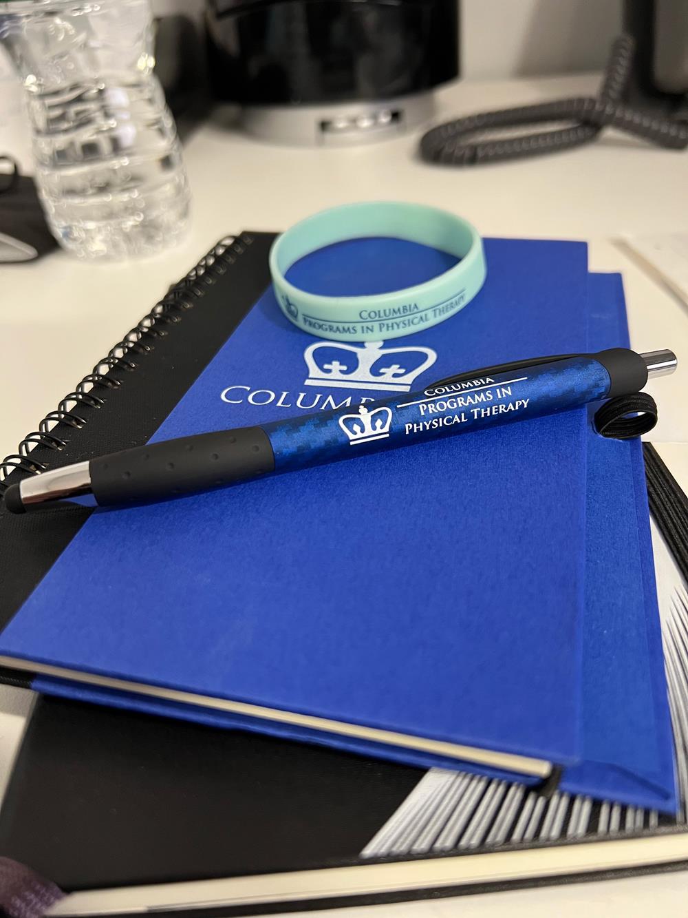 Customer photo from Jason of our Printed Silicone Wristband, a pen on a notebook