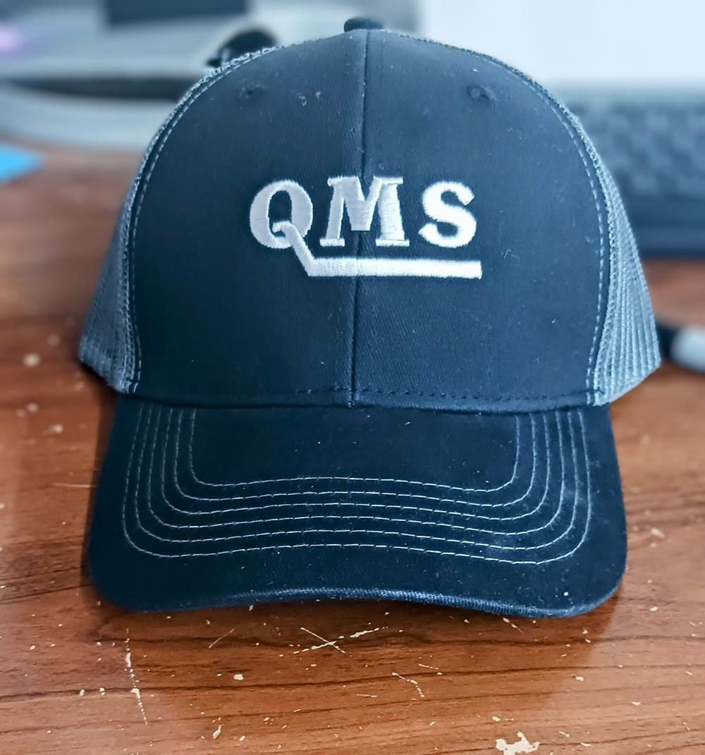 Customer photo from Jennifer of our Colorblocked Twill Meshback Cap, a black hat with white text on it