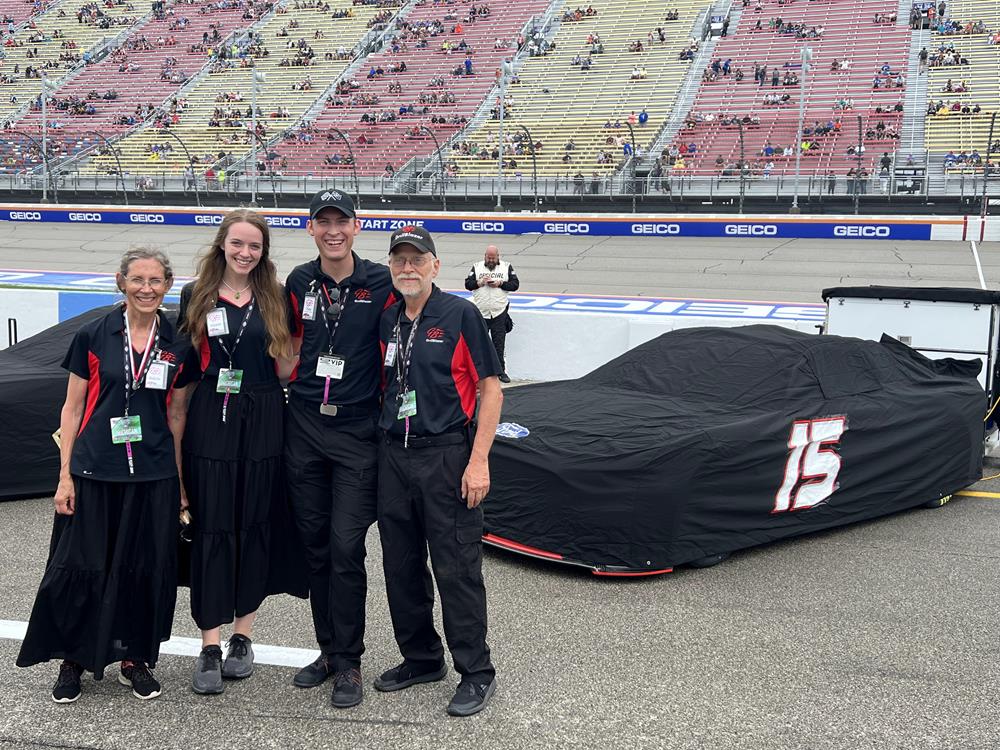 Customer photo from Timothy of our Brushed-Cotton 6-Panel Cap - Embroidered, a group of people standing in front of a race car