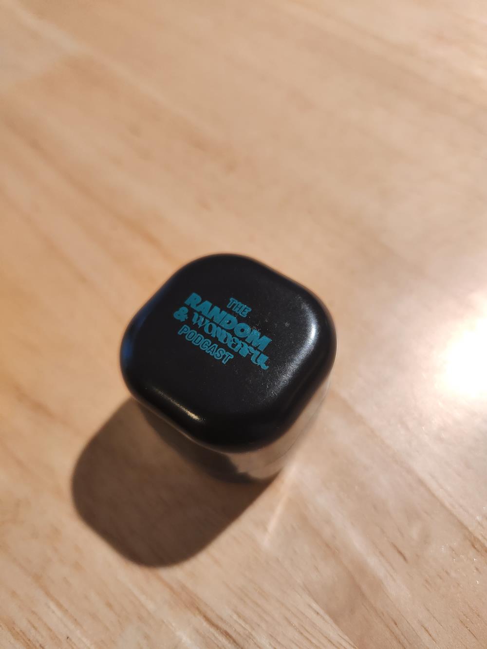 Customer photo from Grace of our Cube Lip Moisturizer - 24 hr, a black box on a wood surface