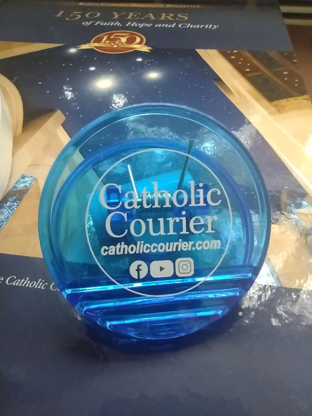 Customer photo from Heidi of our Round Magnet Clip - Translucent, a blue plastic object on a table