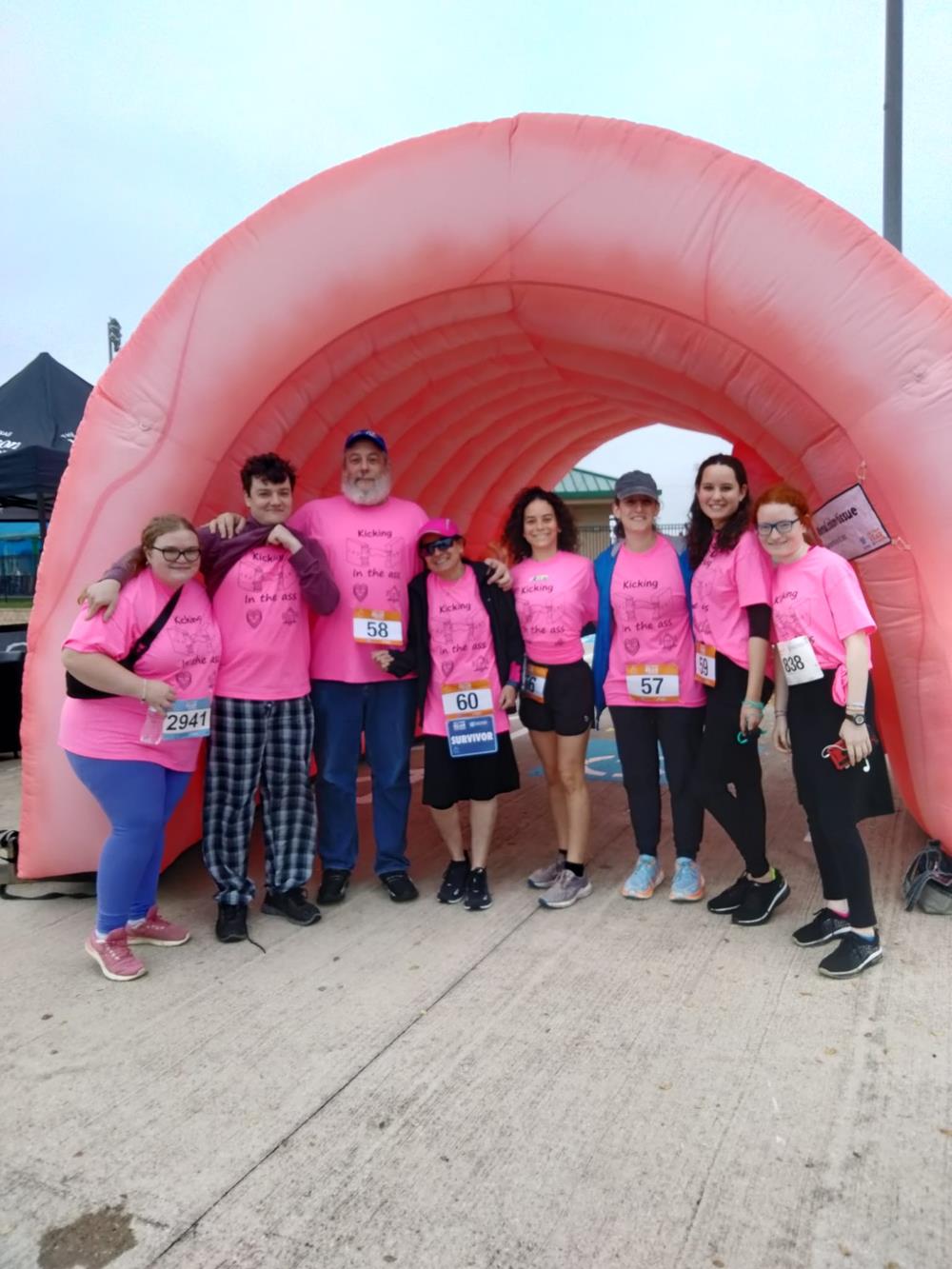 a group of people in pink shirts