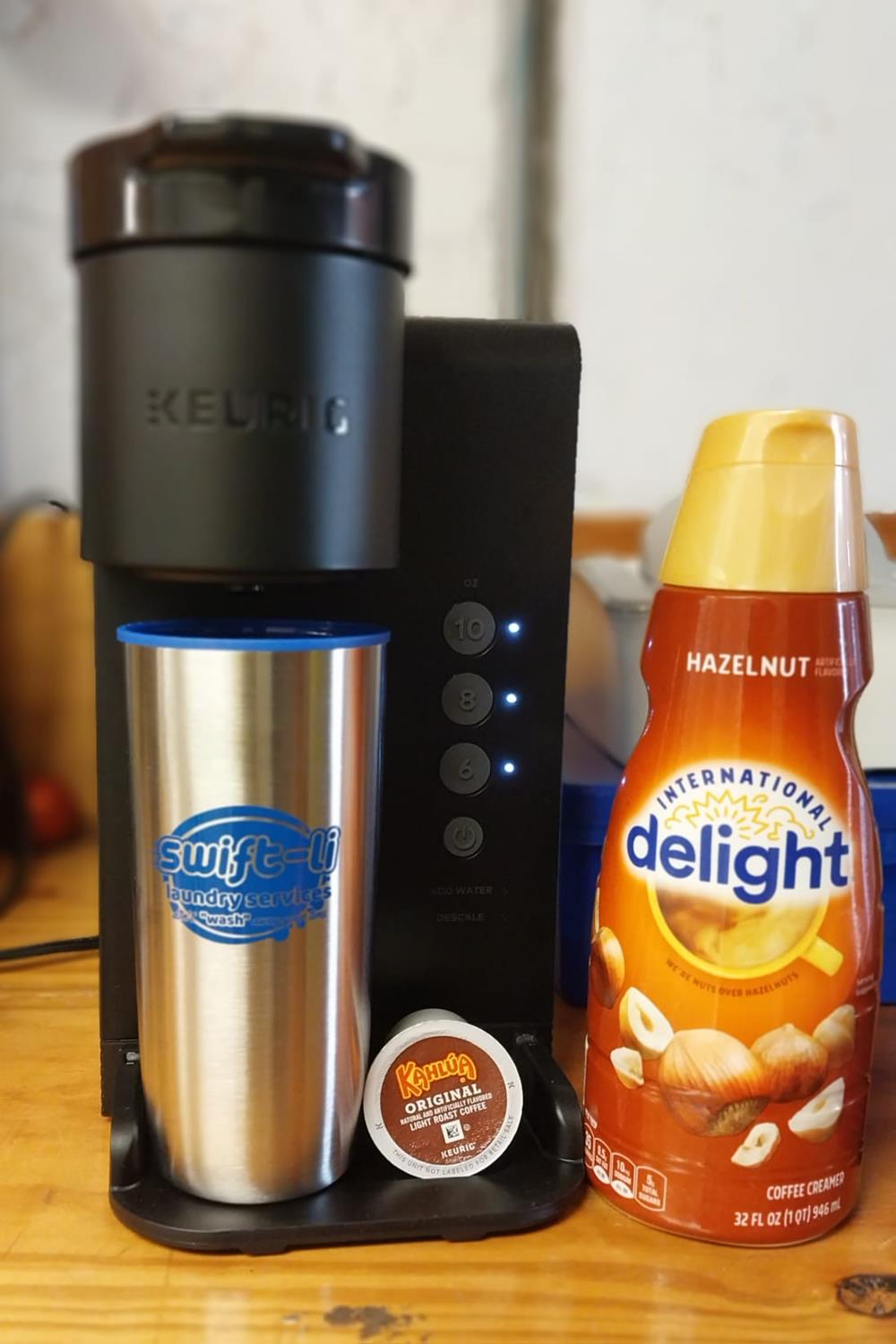a coffee machine and a bottle of creamer