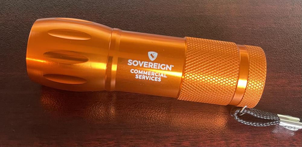 a orange flashlight on a table