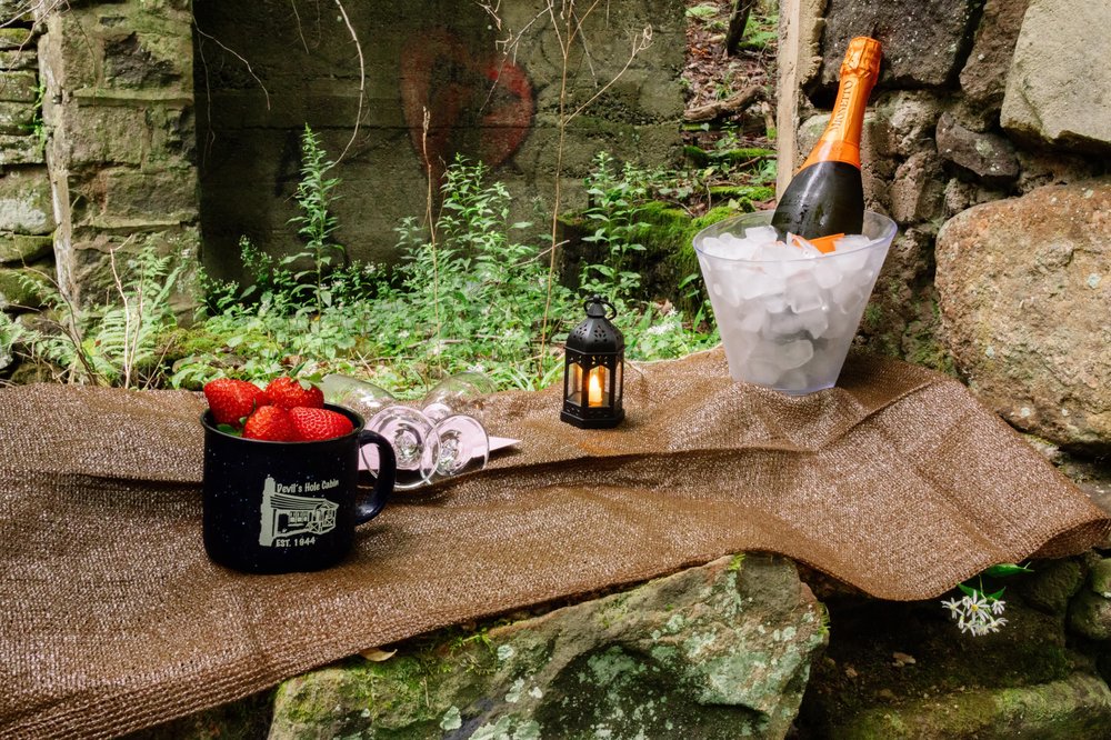Customer photo from Ryan of our Campfire Ceramic Mug - Colors - 15 oz, a champagne bottle in ice bucket and a mug of strawberries