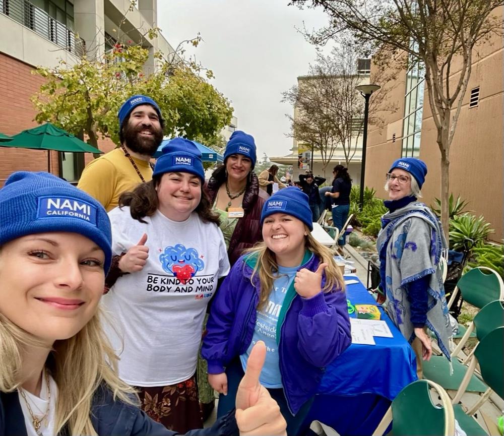 Customer photo from Jolissa of our Cuffed Knit Beanie with Patch, a group of people posing for a photo