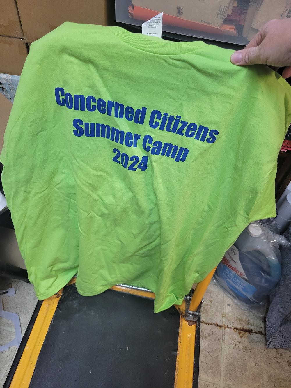 a green shirt with blue text on it