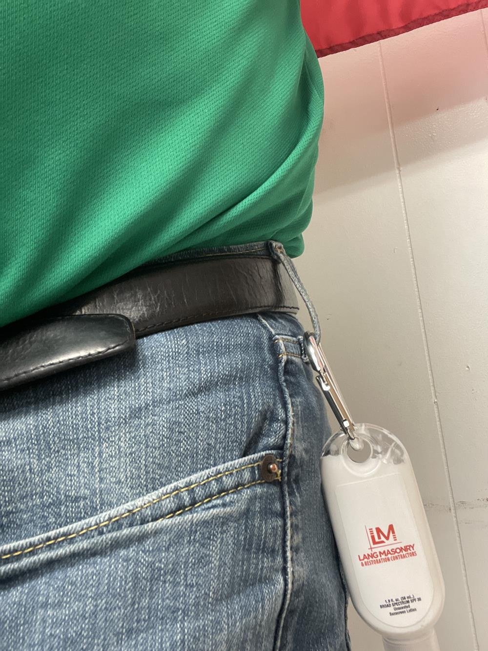 Customer photo from Greg of our Carabiner Sunscreen 1.9 oz. - SPF 30, a person wearing a green shirt and a keychain