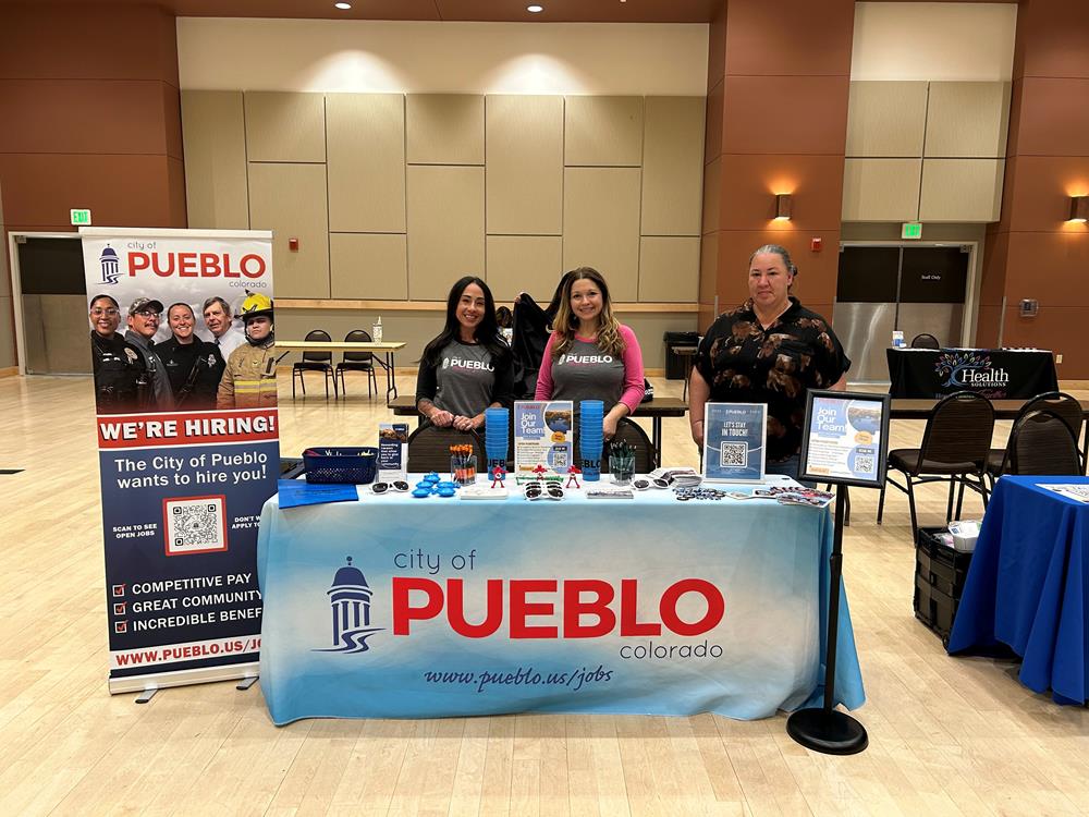 Customer photo from Civil of our Sunglasses, a group of women standing behind a table with signs