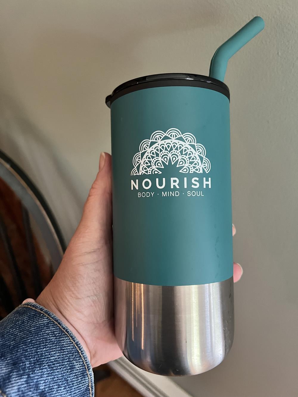Customer photo from Lanta of our Lagom Tumbler with Stainless Straw - 16 oz., a hand holding a blue and silver tumbler