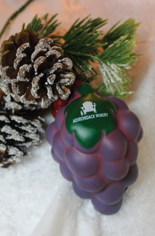 Customer photo from Brittney of our Grapes Stress Reliever, a purple plastic fruit with a green label next to a pine cone