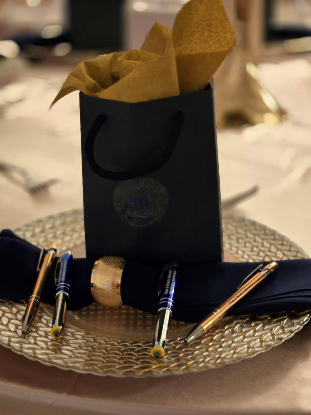 a bag with a napkin and pen on a plate