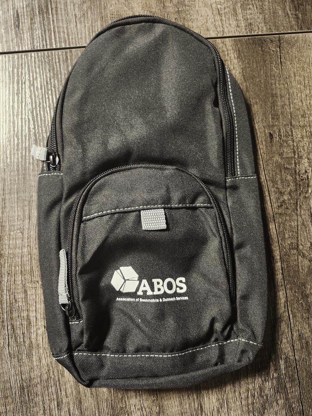 a black backpack on a wood surface