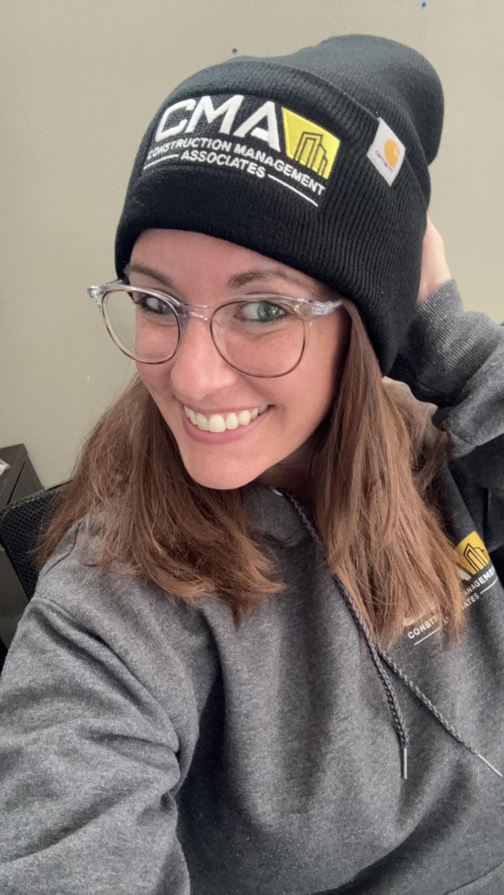 Customer photo from Alison of our Carhartt Acrylic Watch Hat, a woman wearing glasses and a black beanie