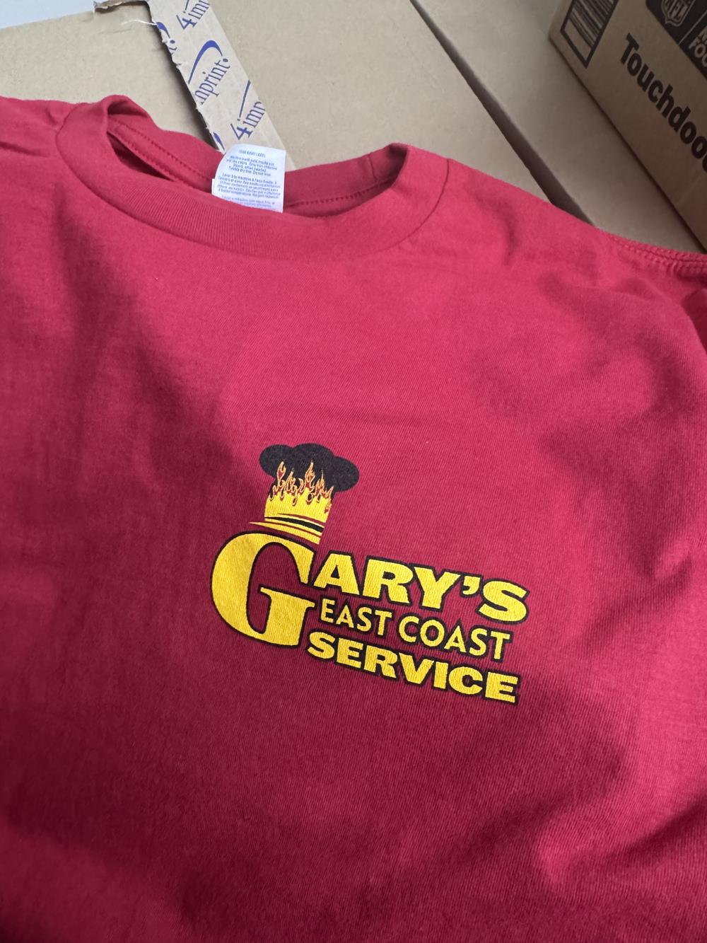 Customer photo from Alyson of our Port & Company Essential Long Sleeve T-Shirt, a red shirt with yellow text on it