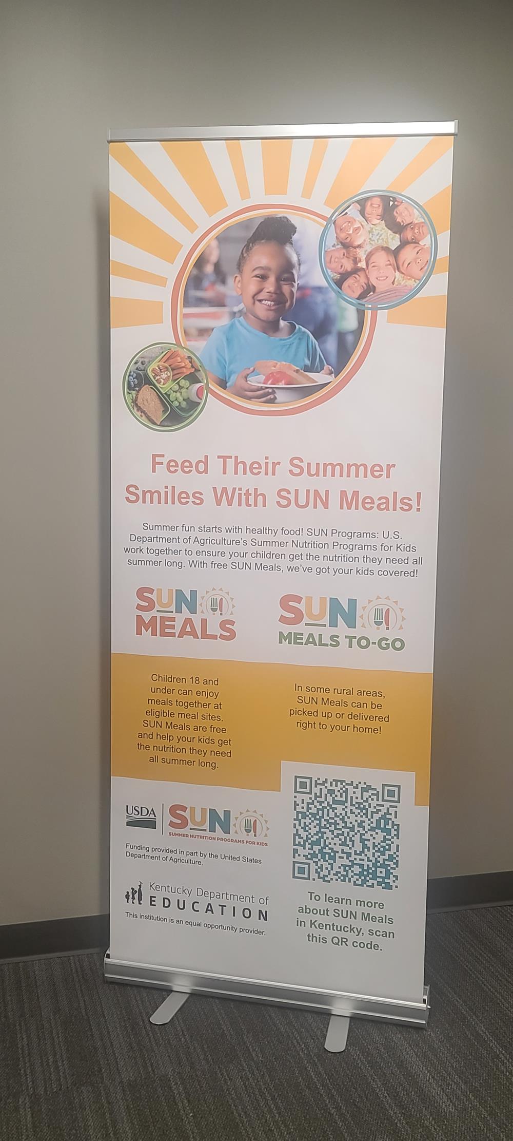 Customer photo from Serena of our Economy Retractable Banner Display - 31 1/2 inches, a sign with a child on it