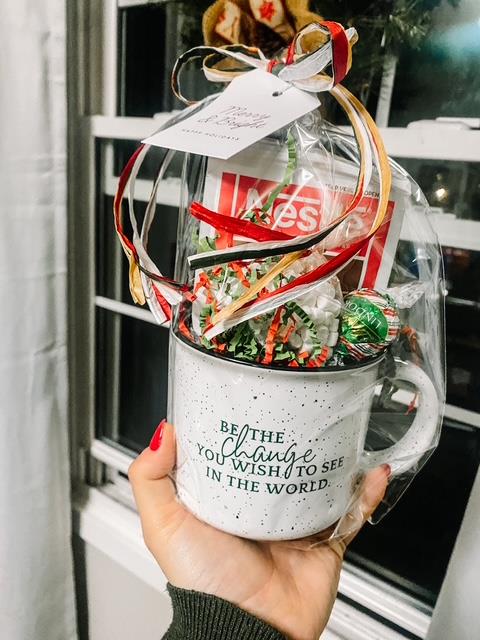 Customer photo from Susan of our Campfire Ceramic Mug - White - 15 oz, a hand holding a mug with a gift in it