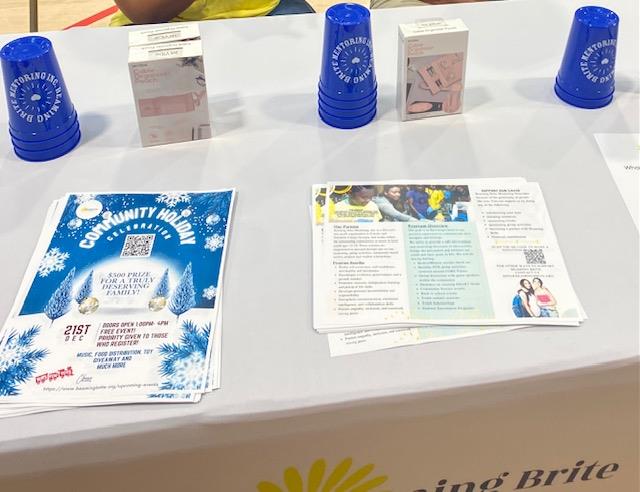 Customer photo from Mona of our Stadium Cup - 16 oz. - Smooth, a table with blue cups and papers