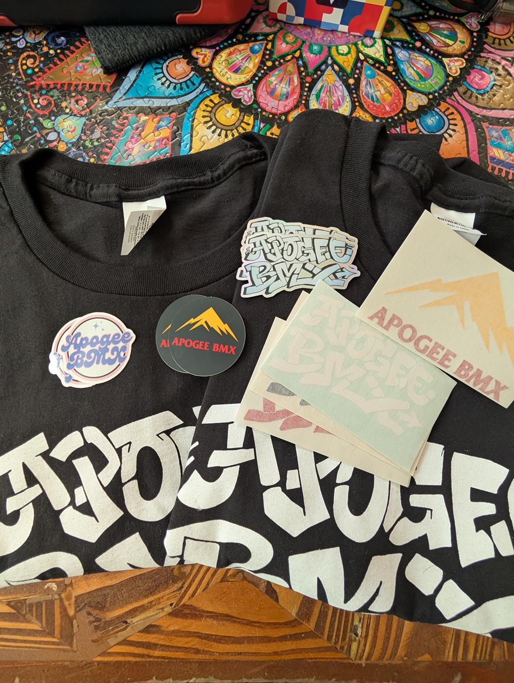 Customer photo from Solomon of our Hanes Authentic T-Shirt - Screen - Colors, a group of black shirts with white text and stickers