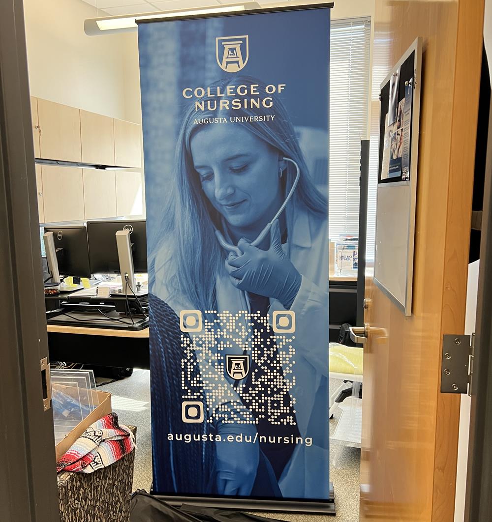 Customer photo from Nina of our Rollup Retractable Banner Display, a sign in a room
