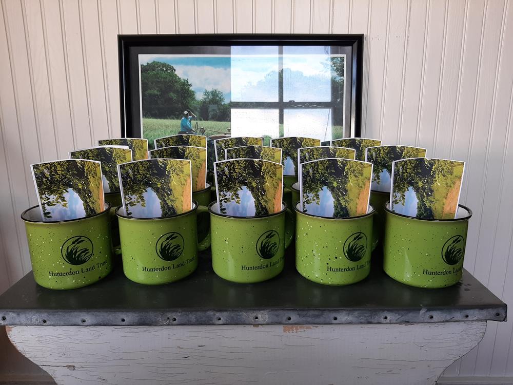 Customer photo from Laura of our Campfire Ceramic Mug - Colors - 15 oz., a group of green mugs with a picture of a golf course