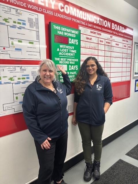 Customer photo from Eileen of our Performance Tek Bonded Microfleece Jacket - Ladies', two women standing next to a sign