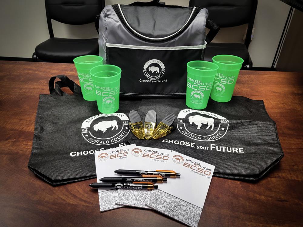 Customer photo from Brandon of our Power Clip - Translucent, a bag with green cups and pens on a table