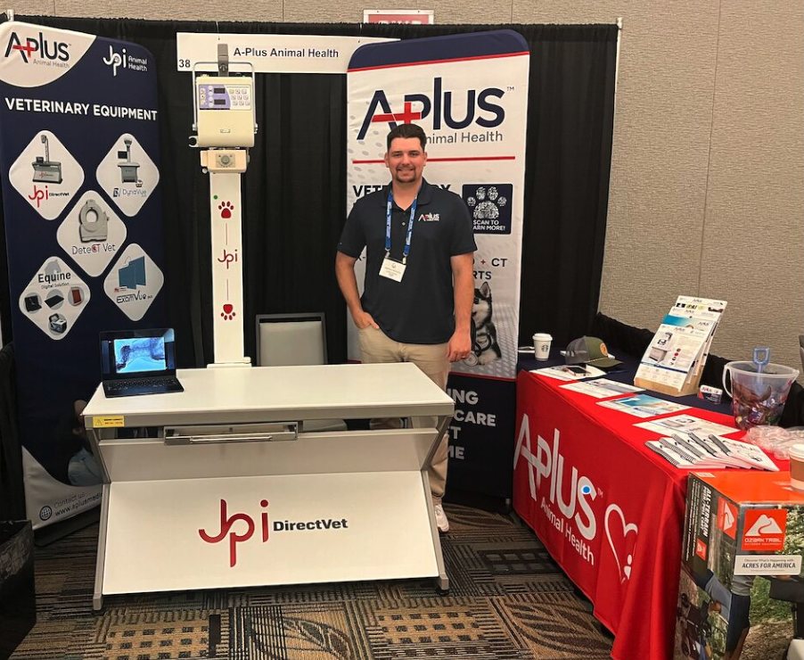 Customer photo from Jeanette of our EuroFit Banner Stand - 7-1/2' x 3', a man standing in front of a table