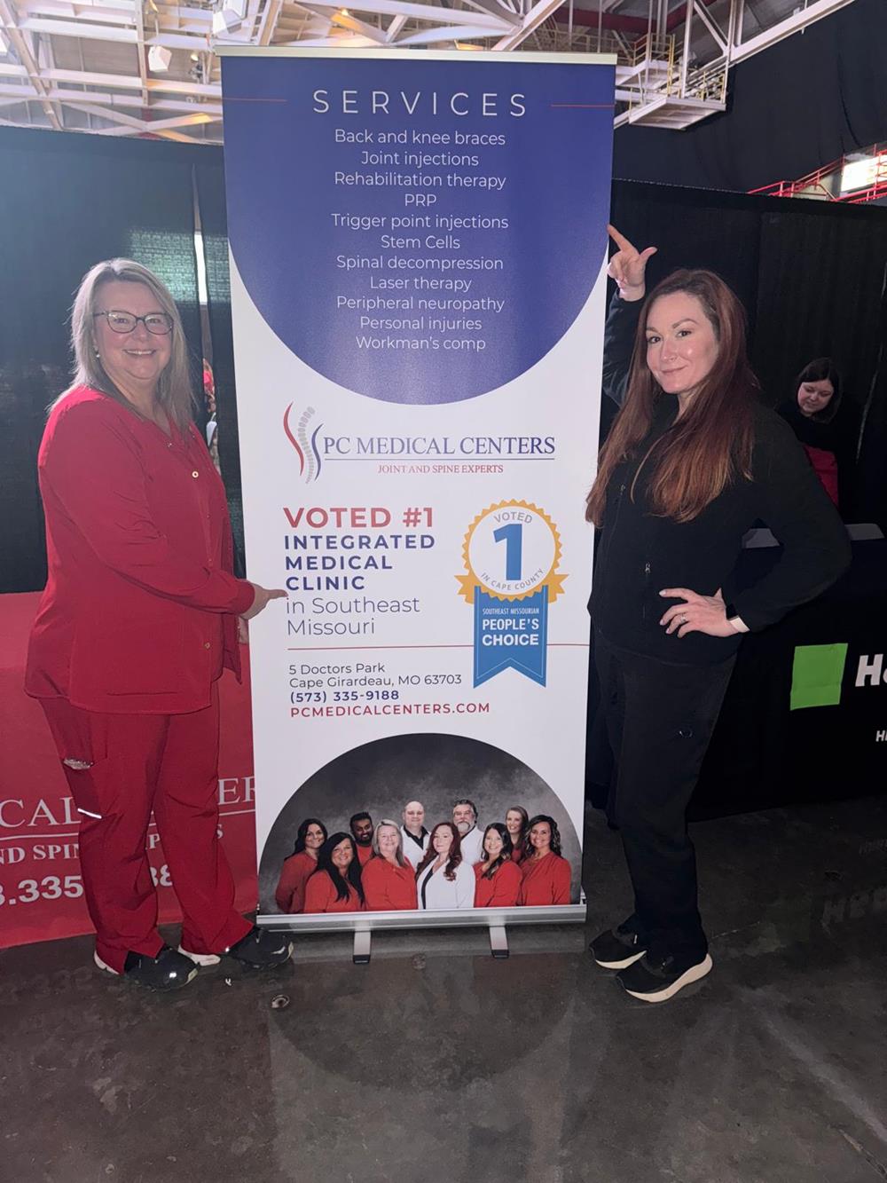 Customer photo from Greg of our Cubano Pen - Opaque, two women standing next to a sign