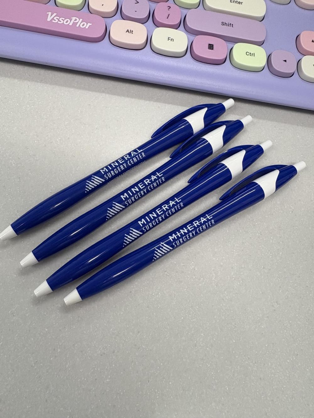 Customer photo from Brooke of our Javelin Pen, a group of blue pens next to a keyboard