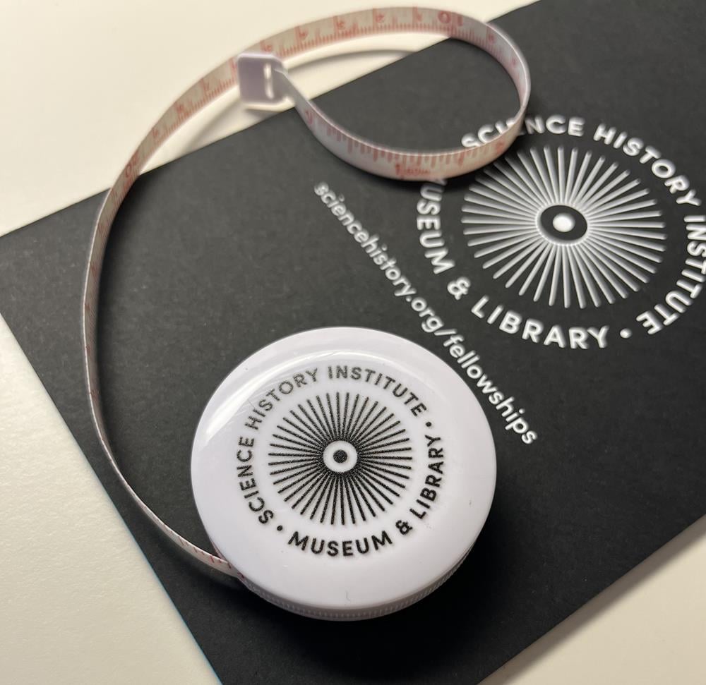 Customer photo from Charlotte of our Deluxe Fabric Tape Measure - Opaque, a tape measure on a black paper