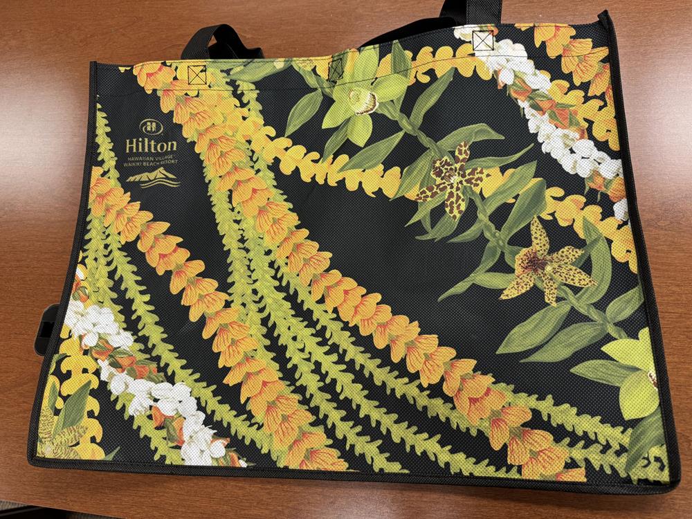 Customer photo from Lora of our Full Color Shopping Tote - 14-3/4" x 19-3/4" - 2 Sided, a black bag with yellow and white flowers on it